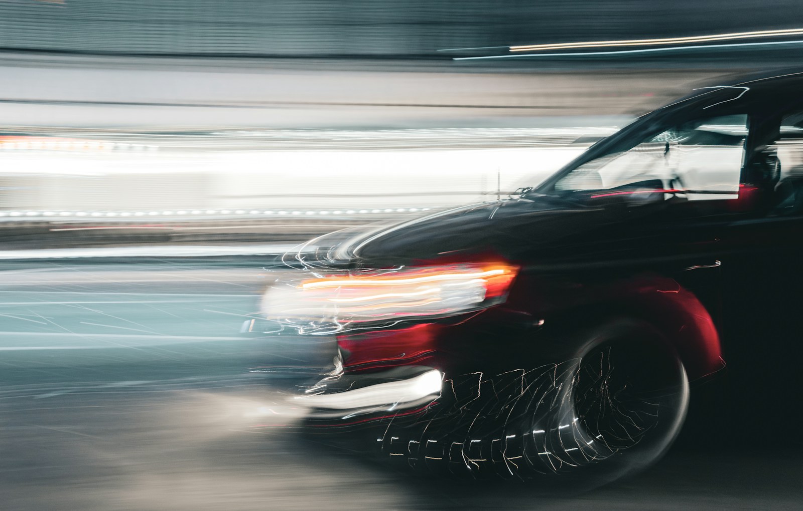 A car streaking past with light trails