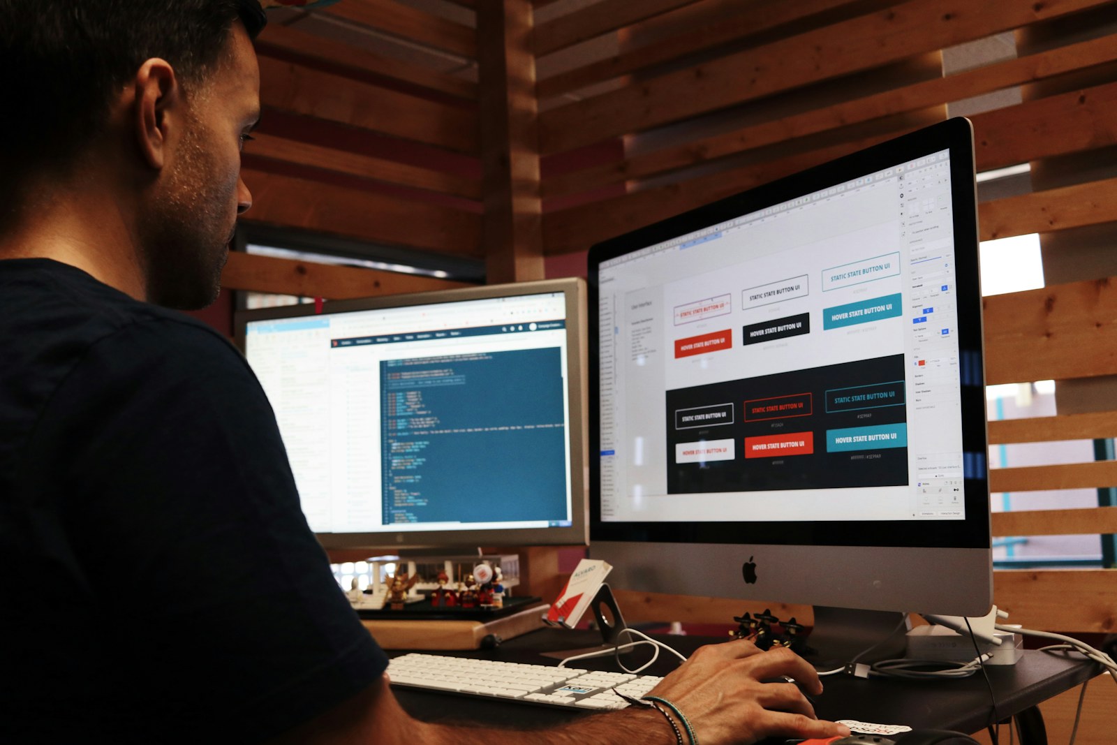 A creative working across multiple screens in a studio