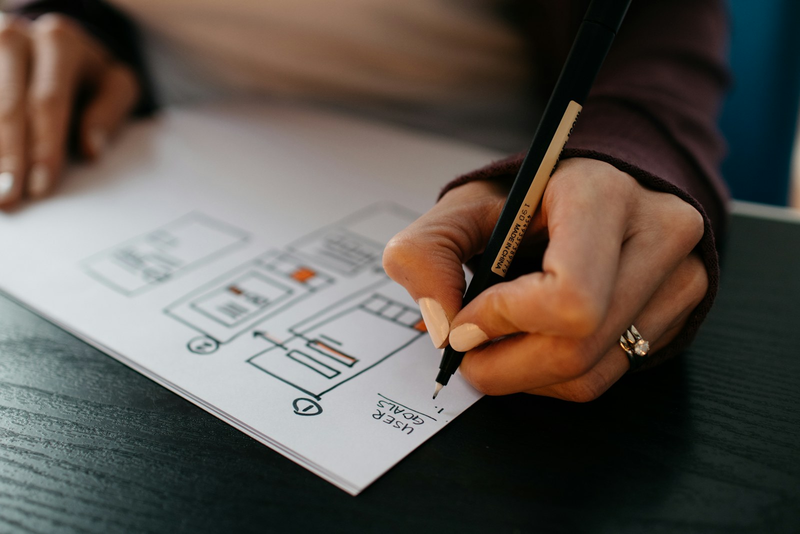 A designer sketching interface concepts by hand