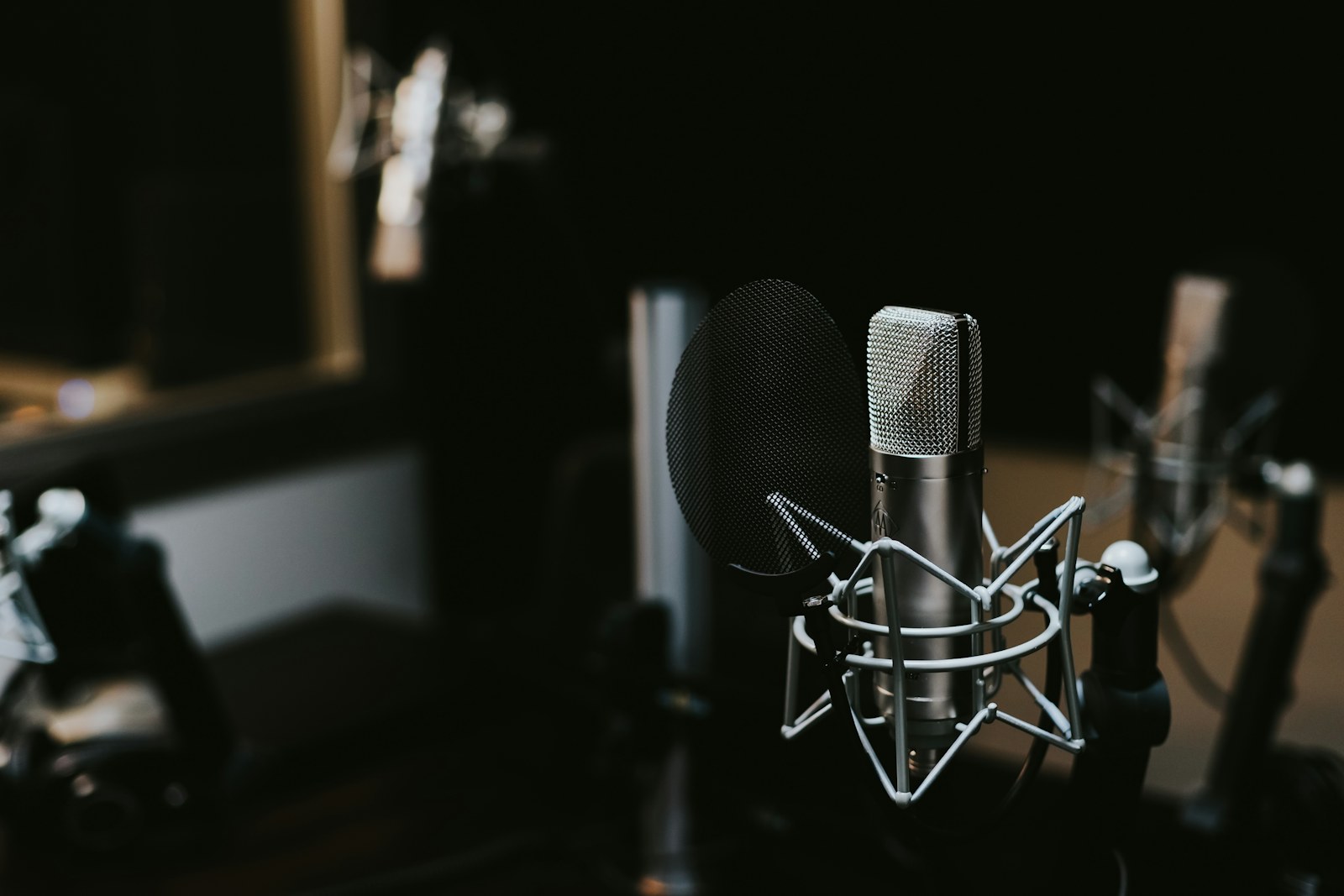 A studio microphone in a dark recording room