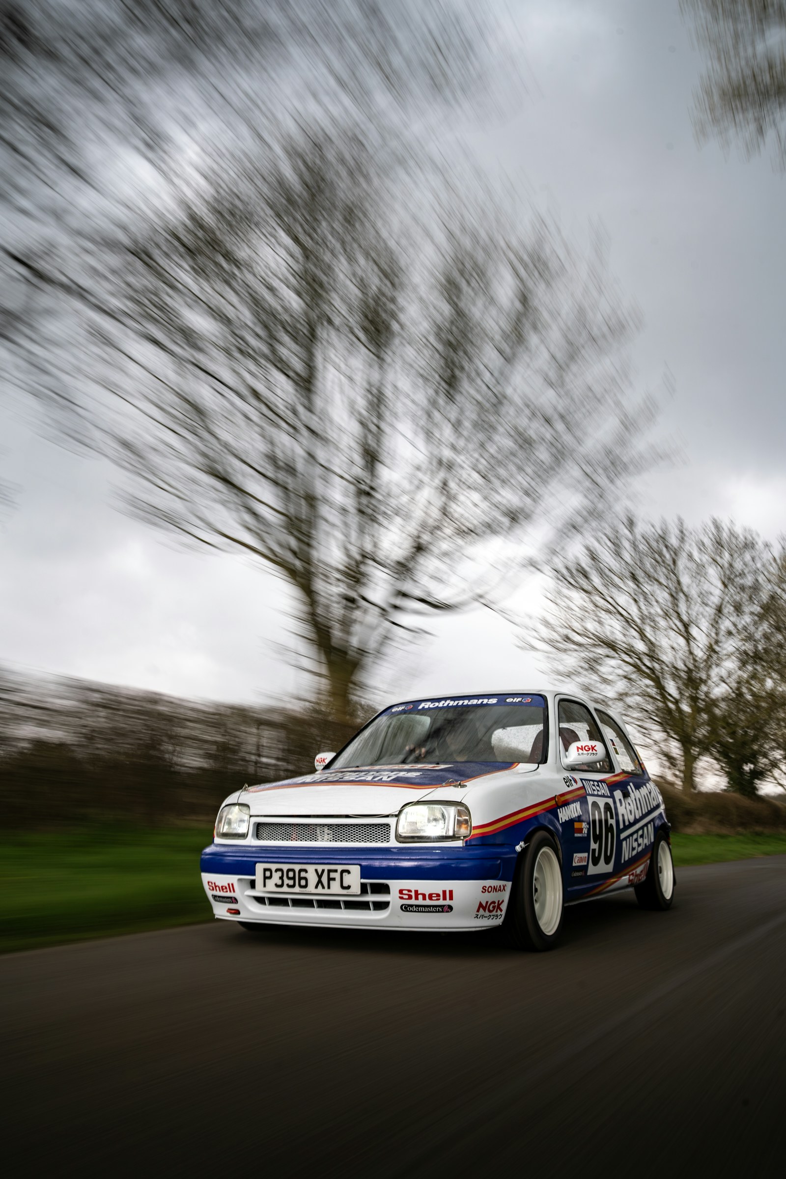 A rally hatchback cornering on a country road