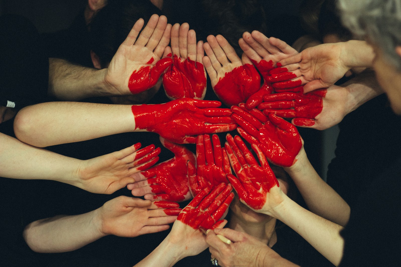 Many hands joined together in a circle